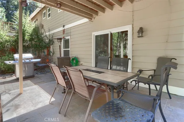 a backyard of a house with table and chairs