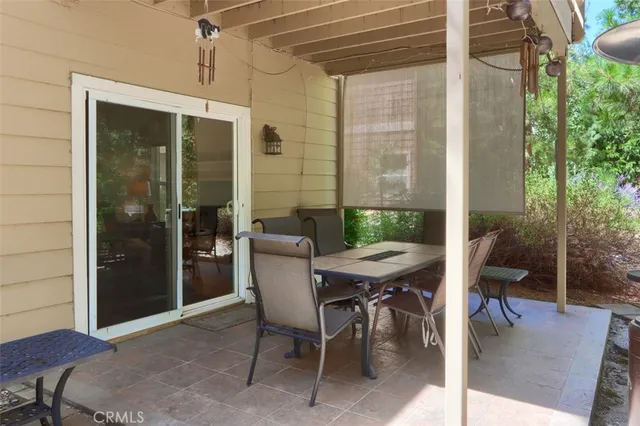a view of a patio with table and chairs and potted plants