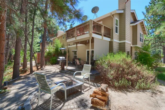 a view of a building with yard and sitting area