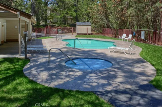a swimming pool with outdoor seating and yard
