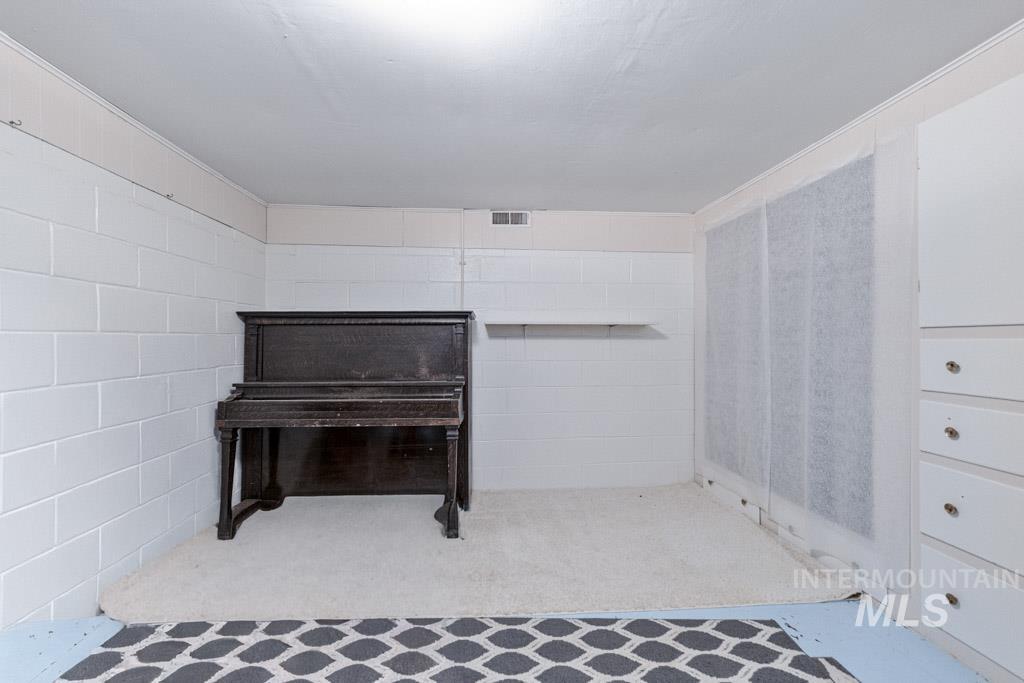 259 Highway 12 Pomeroy, WA 99347 - Photo 27 of 45 Interior space featuring painted block walls, a white ceiling, and light-colored carpet
