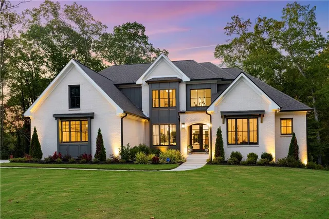 a front view of a house with a garden