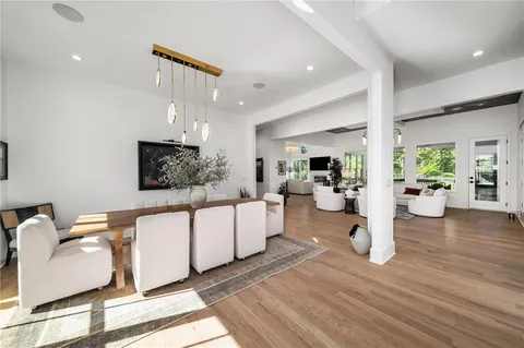 a kitchen with stainless steel appliances granite countertop a sink a stove and a wooden floors