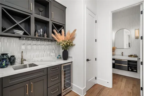 a bathroom with a granite countertop sink a toilet a mirror and shower