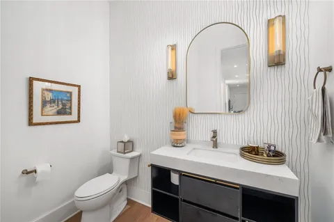 a bedroom with a bed a chandelier and couches