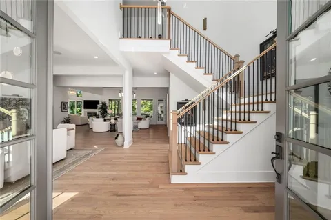 a living room with furniture a table and wooden floor