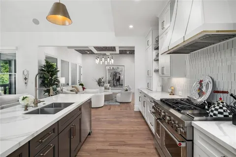 a bathroom with a granite countertop sink a toilet a mirror and shower