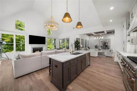 a view of a hallway with wooden floor and stairs