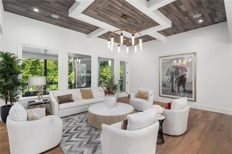 a large kitchen with stainless steel appliances granite countertop a stove and a view of living room