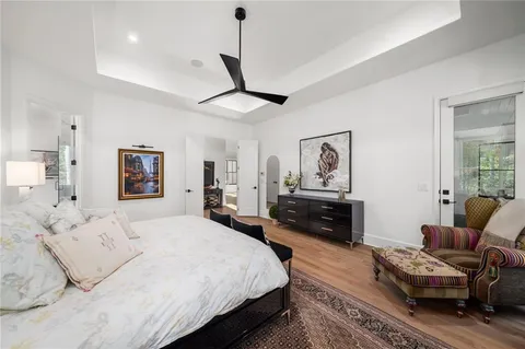 a view of a white house with a large tree