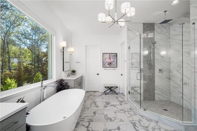 an aerial view of a house with a yard and lake view