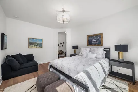 a view of a big house with a big yard plants and large trees