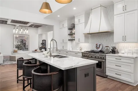 a living room with furniture a flat screen tv and a large window