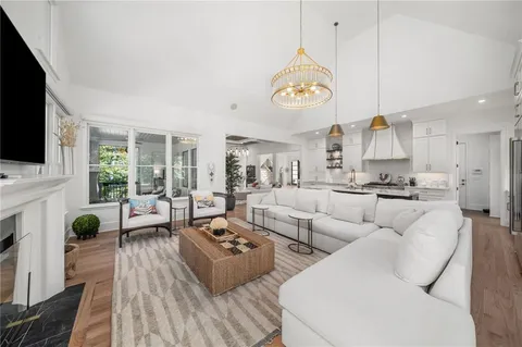 a bedroom with a bed a couch and large window