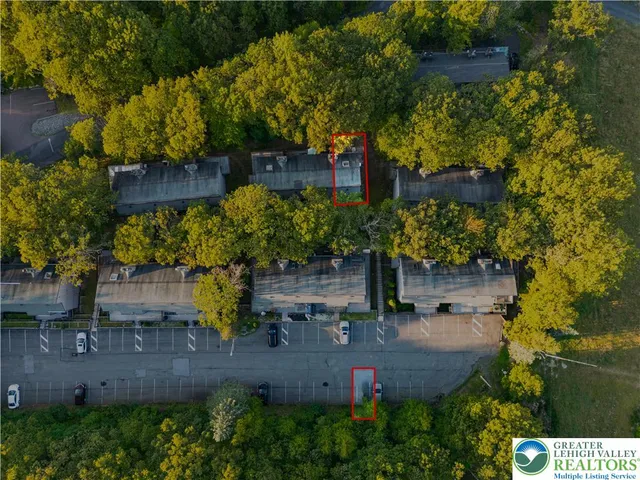 an aerial view of a house with a yard and large tree