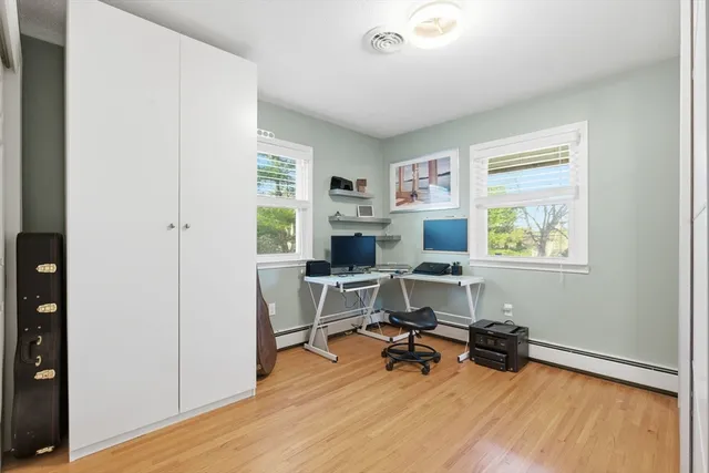 a view of a workspace with furniture and a window
