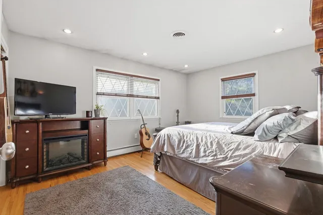 a bedroom with a bed and a flat screen tv