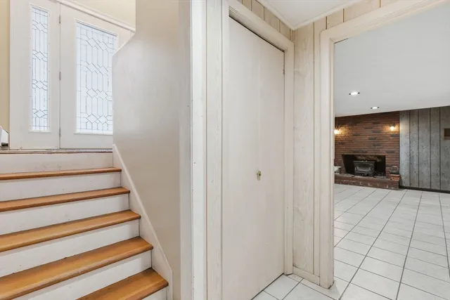 a view of entryway and bedroom with wooden floor