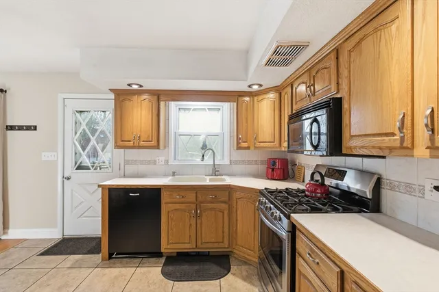 a kitchen with a sink stove and cabinets