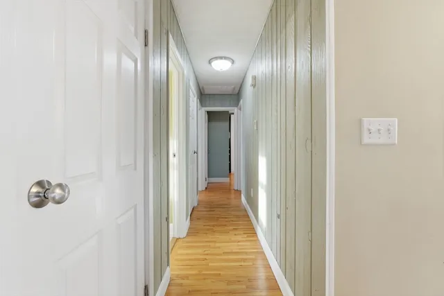 a view of a hallway with wooden floor
