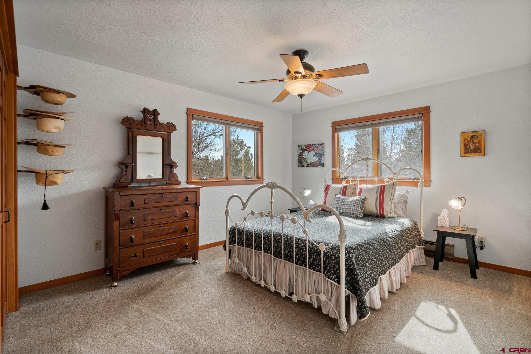 333 Pine Ridge Loop, Unit 4 Durango, CO 81301 - Photo 15 of 33 a bedroom with a bed and a chandelier