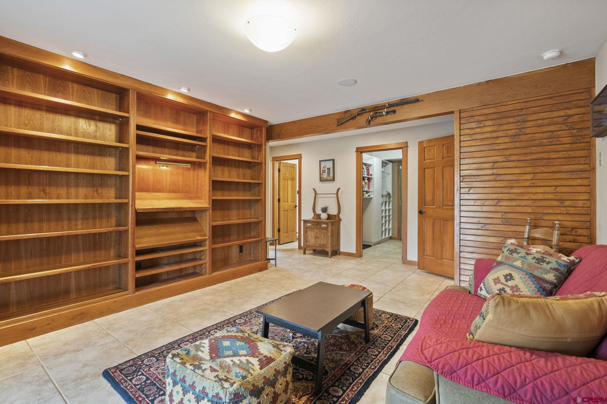 333 Pine Ridge Loop, Unit 4 Durango, CO 81301 - Photo 22 of 33 a living room with furniture and a book shelf
