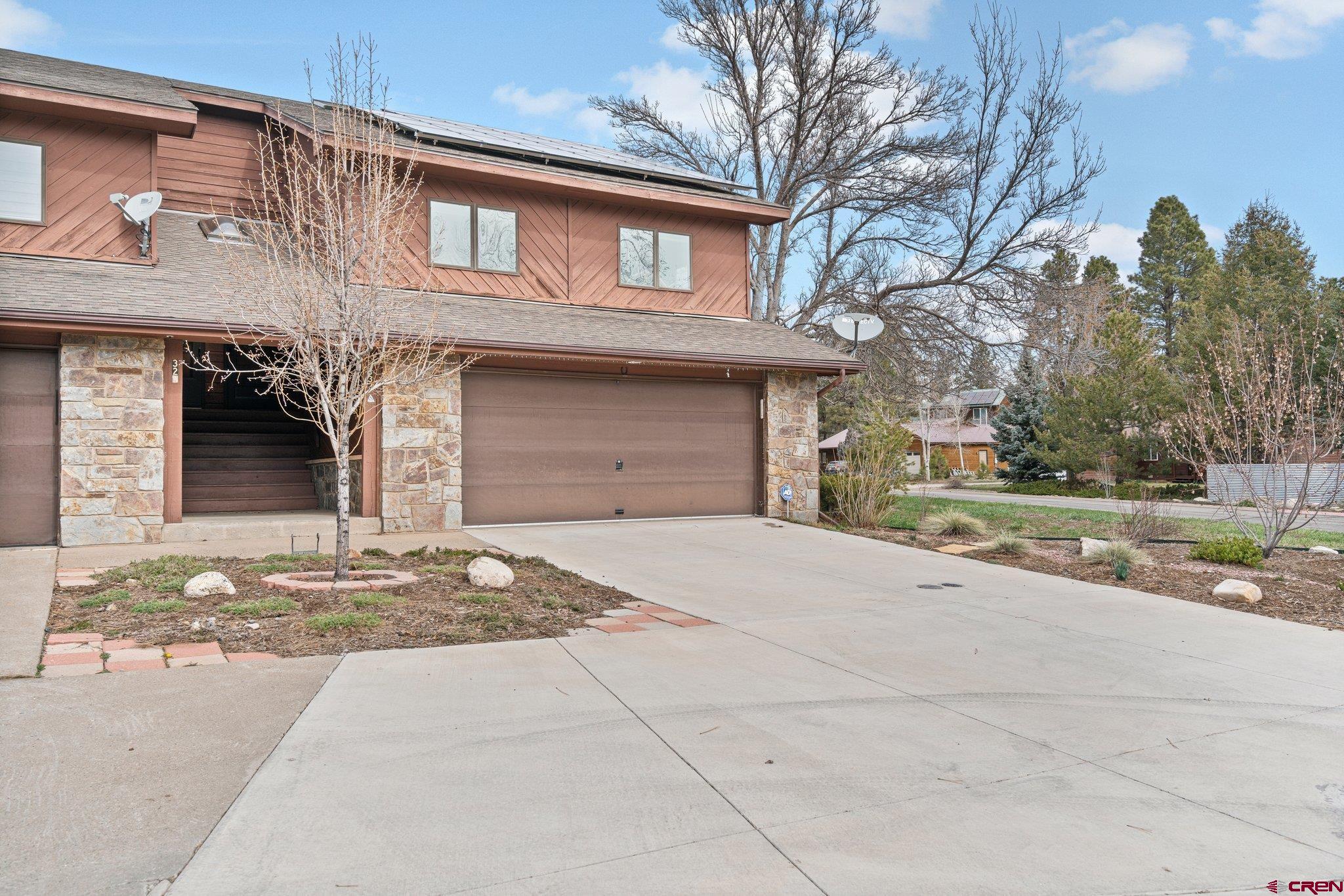 333 Pine Ridge Loop, Unit 4 Durango, CO 81301 - Photo 32 of 33 a front view of a house with a yard and garage
