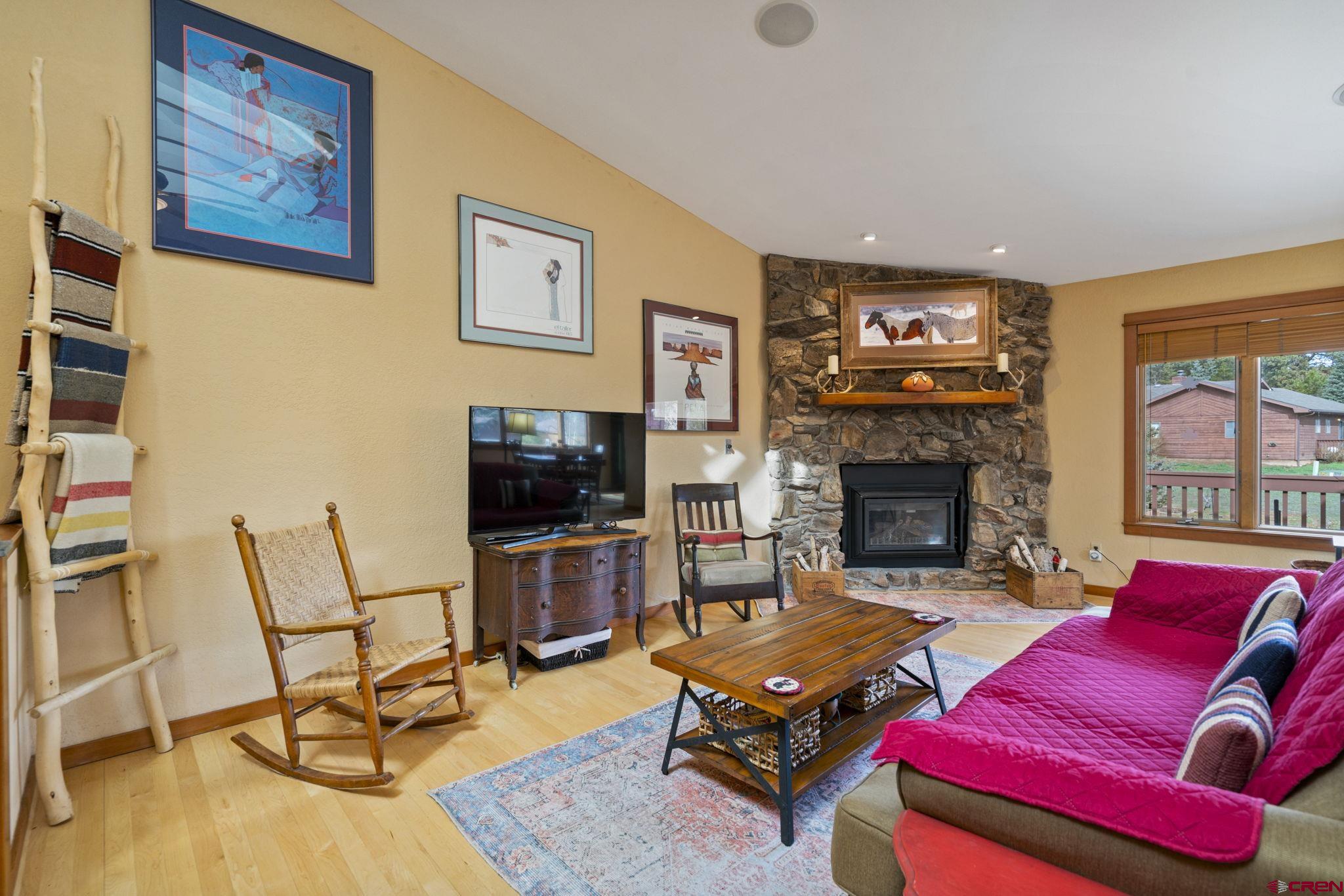 333 Pine Ridge Loop, Unit 4 Durango, CO 81301 - Photo 5 of 33 a living room with furniture a flat screen tv and a fireplace