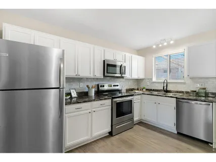 a bathroom with sink mirror and bathtub
