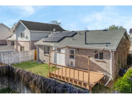 a view of a house with a yard and deck