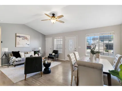 a living room with furniture potted plant a sink and a view mirror