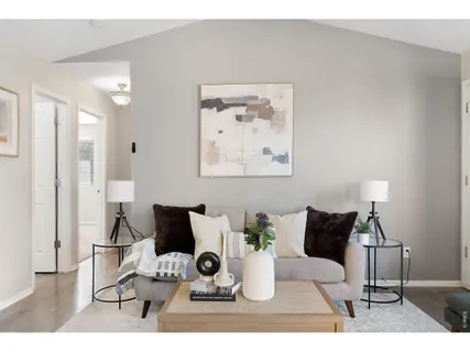 a living room with furniture and a potted plant