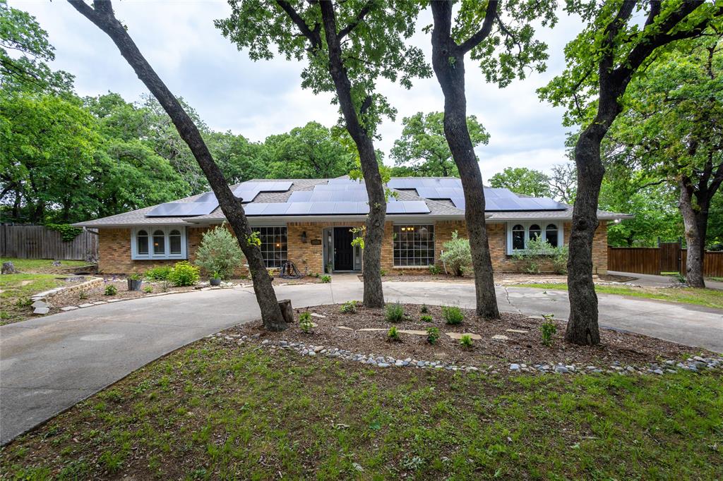 5609 Trail Lake Drive Arlington, TX 76016 - Photo 1 of 1 a front view of a house with garden and trees