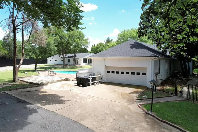 a view of house with outdoor space and swimming pool