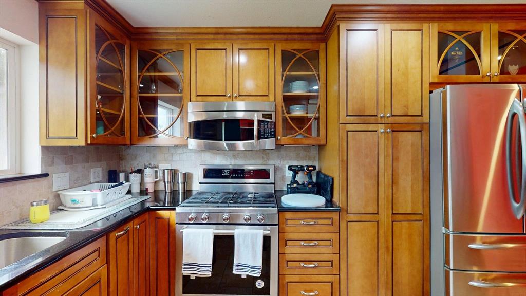 1206 South Clark Road Duncanville, TX 75137 - Photo 12 of 38 a kitchen with stainless steel appliances granite countertop a refrigerator and a stove top oven