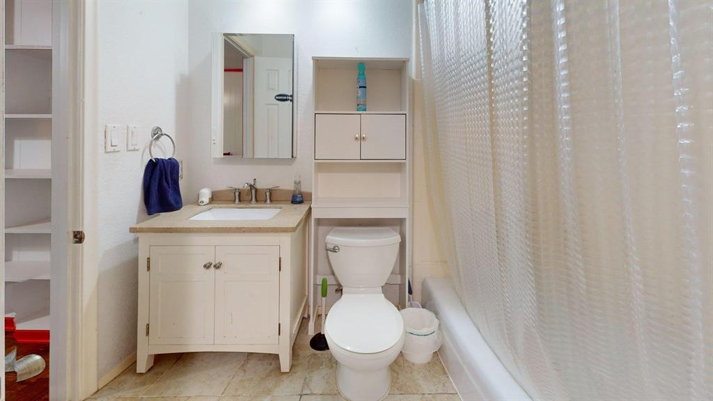 1206 South Clark Road Duncanville, TX 75137 - Photo 14 of 38 a bathroom with a sink toilet and mirror