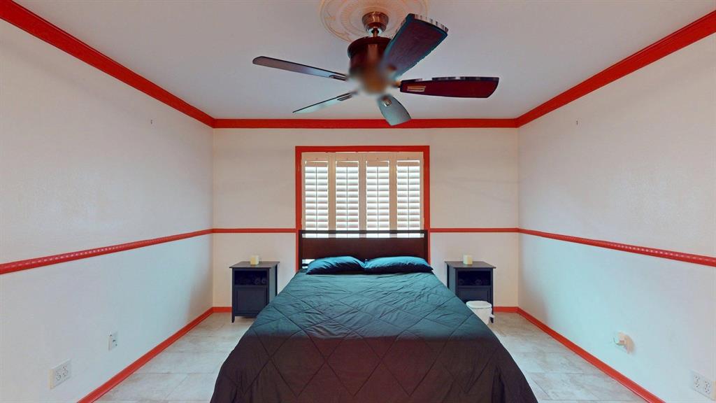 1206 South Clark Road Duncanville, TX 75137 - Photo 18 of 38 a bedroom with a bed and a chandelier