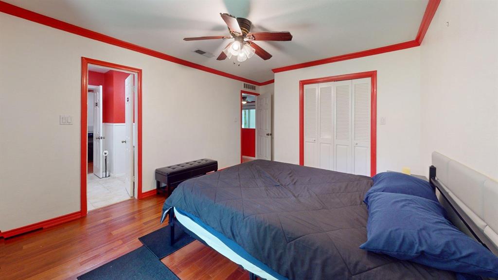 1206 South Clark Road Duncanville, TX 75137 - Photo 23 of 38 a bedroom with a bed and a chandelier