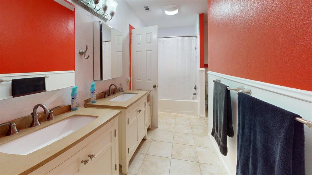 1206 South Clark Road Duncanville, TX 75137 - Photo 25 of 38 a bathroom with a double vanity sink and mirror