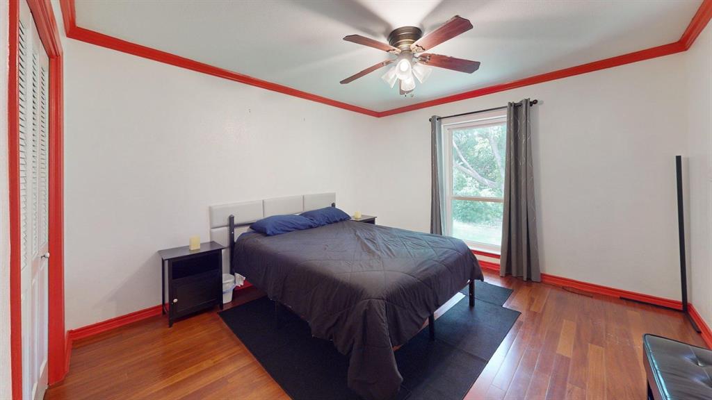 1206 South Clark Road Duncanville, TX 75137 - Photo 26 of 38 a spacious bedroom with a bed and a chandelier