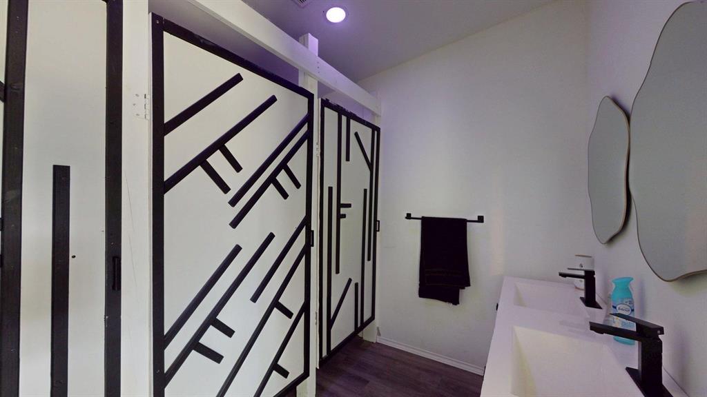 1206 South Clark Road Duncanville, TX 75137 - Photo 30 of 38 a view of a hallway with wooden floor and stairs