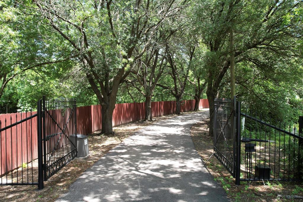 1206 South Clark Road Duncanville, TX 75137 - Photo 5 of 38 a view of a backyard with wooden fence and large trees