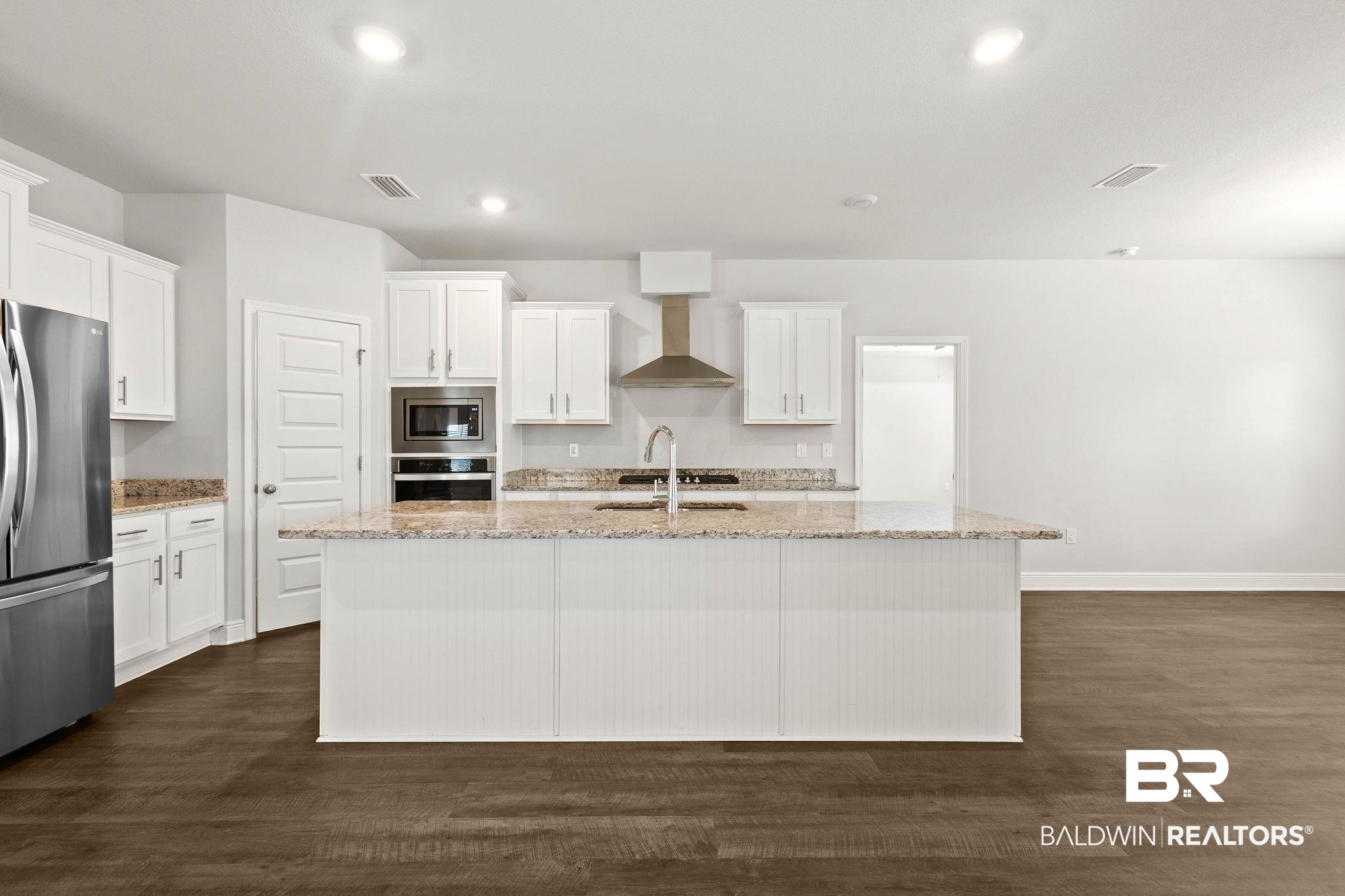 9448 Amethyst Drive Daphne, AL 36526 - Photo 15 of 61 Kitchen featuring white cabinets, light stone counters, stainless steel appliances, dark wood-style floors, and recessed lighting