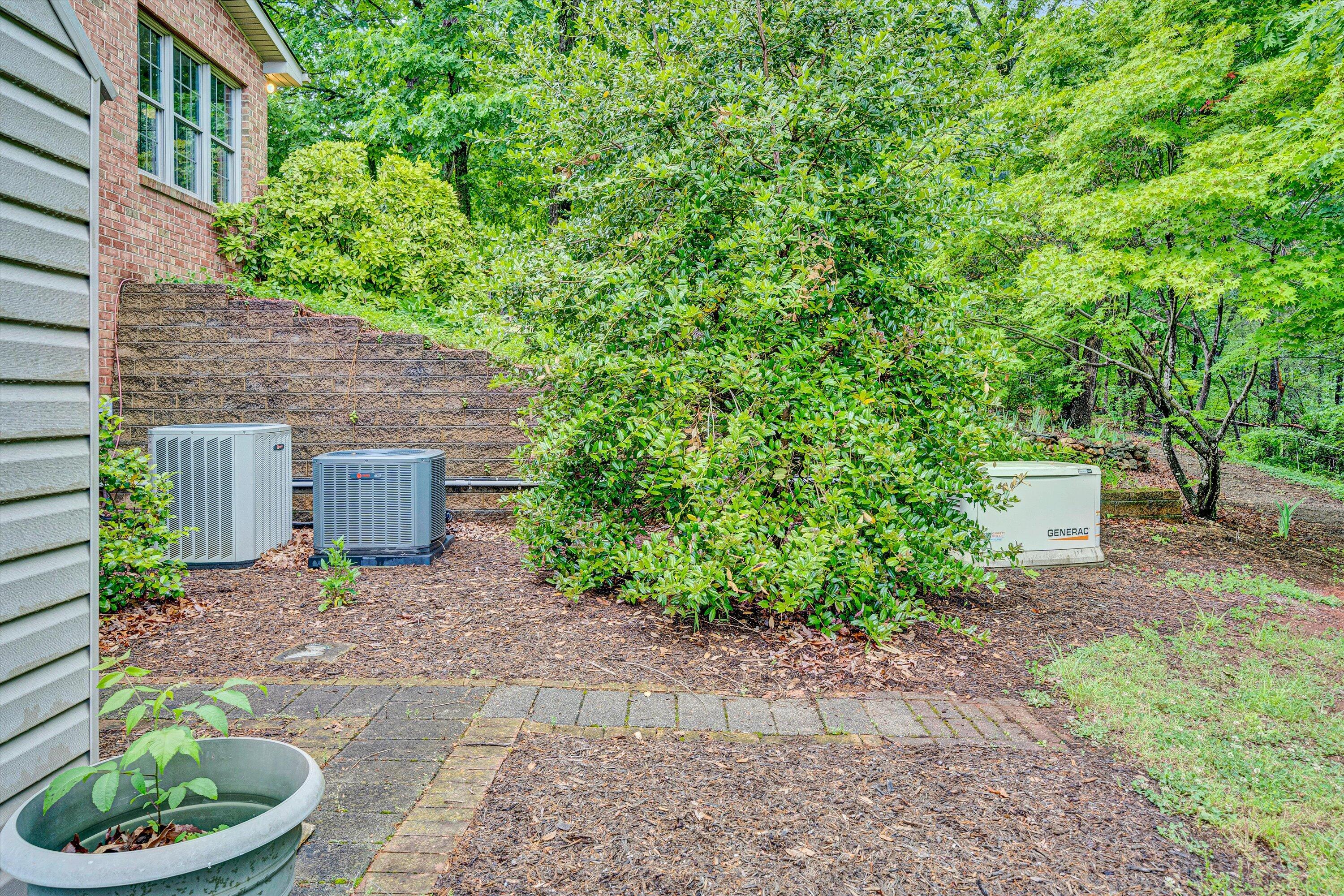 5531 Bethlehem Road Boones Mill, VA 24065 - Photo 67 of 69 a backyard of a house with a fountain plants and large tree