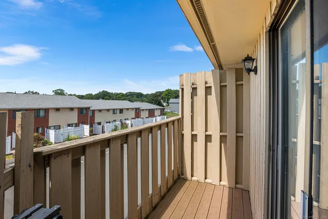 a view of a house with a deck and wooden floor