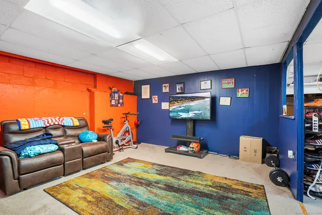 a bedroom with furniture and a flat screen tv