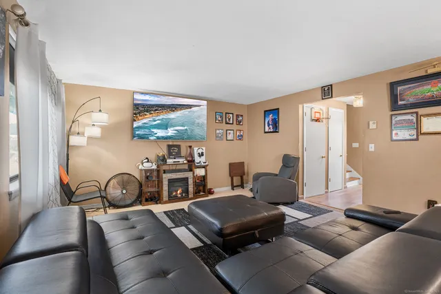 a living room with furniture a couch and a bookshelf