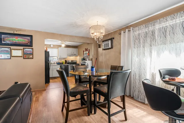 a view of a dining room with furniture and chandelier