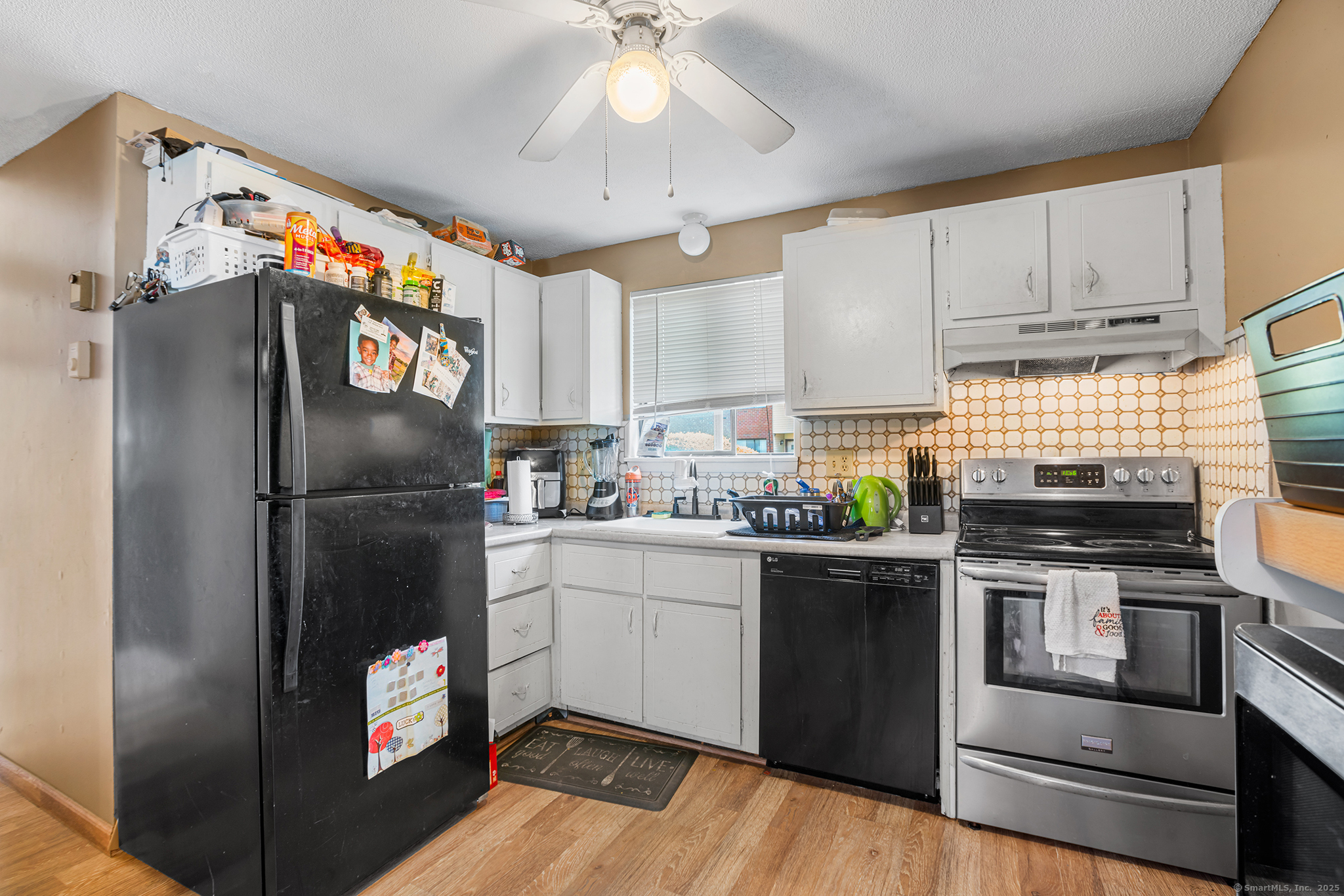 205 Homestead Street, Unit B3 Manchester, CT 06042 - Photo 7 of 26 a kitchen with stainless steel appliances granite countertop a refrigerator a stove a sink and a microwave