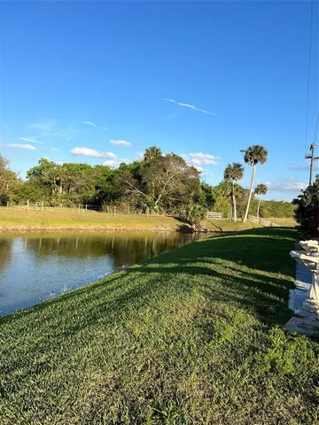 a view of a lake with houses in the background